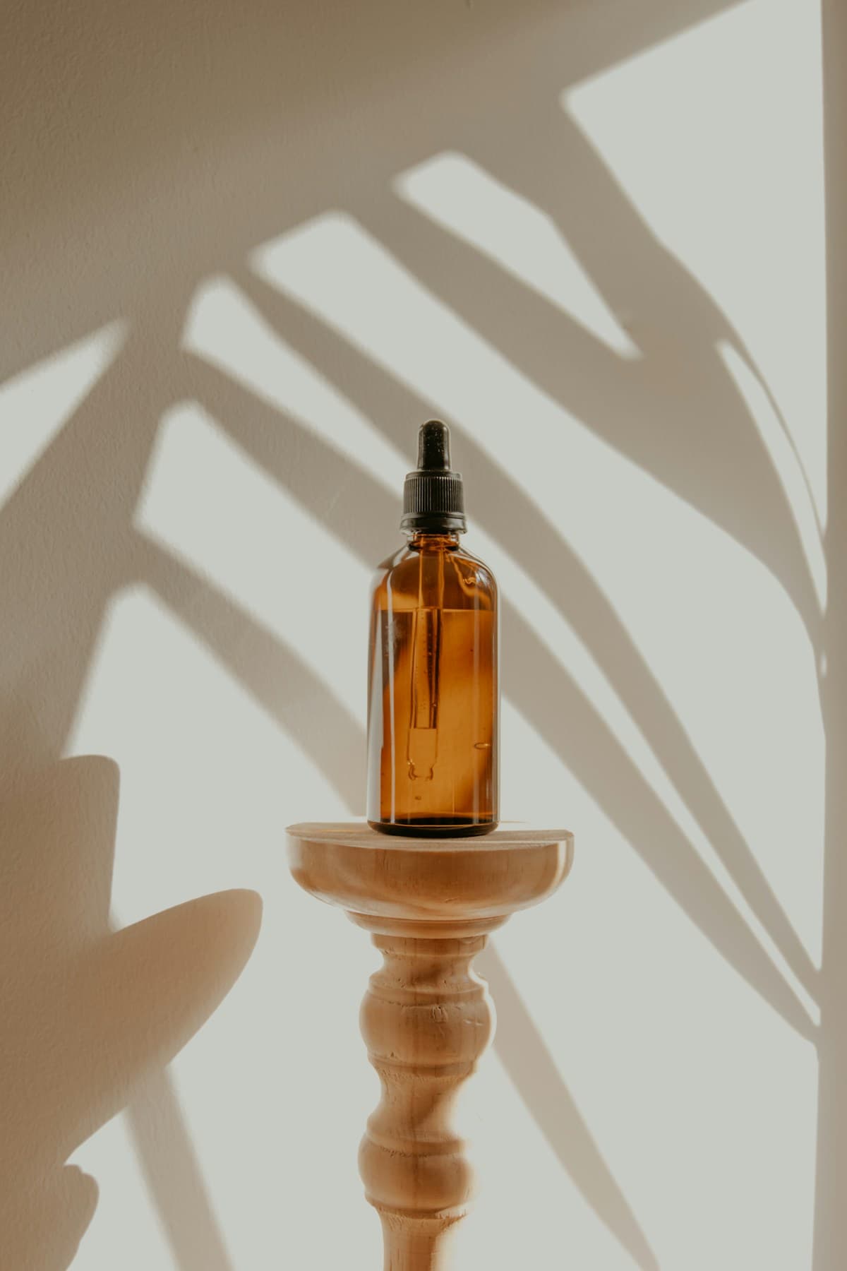 Amber skincare bottle in natural light, used in an illustrative ad concept